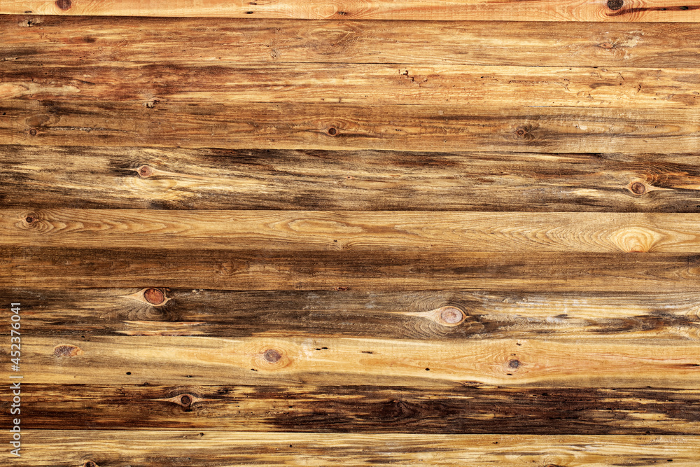 Fototapeta premium Yellow wooden wall with old boards, texture of natural materials.