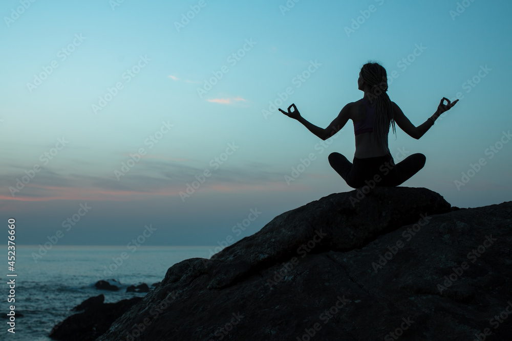 Silhouette of yoga woman on the shore of ocean at evening. Silhouette of yoga woman on the shore of ocean at evening.