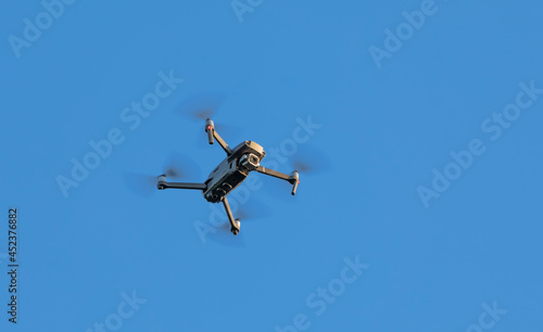 Quadcopter on a background of blue sky. Aerial photography.