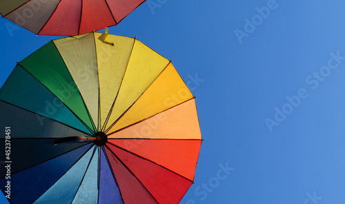 street decorated with colorful umbrellas in the blue sky