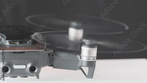 Drone quadcopter engine initiation back view, futuristic gadget and electronics, professional tool for video and photo 60 fps 4K