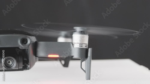 Drone quadcopter engine initiation and rotation left side, futuristic gadget and electronics, professional tool for video and photo 60 fps 4K