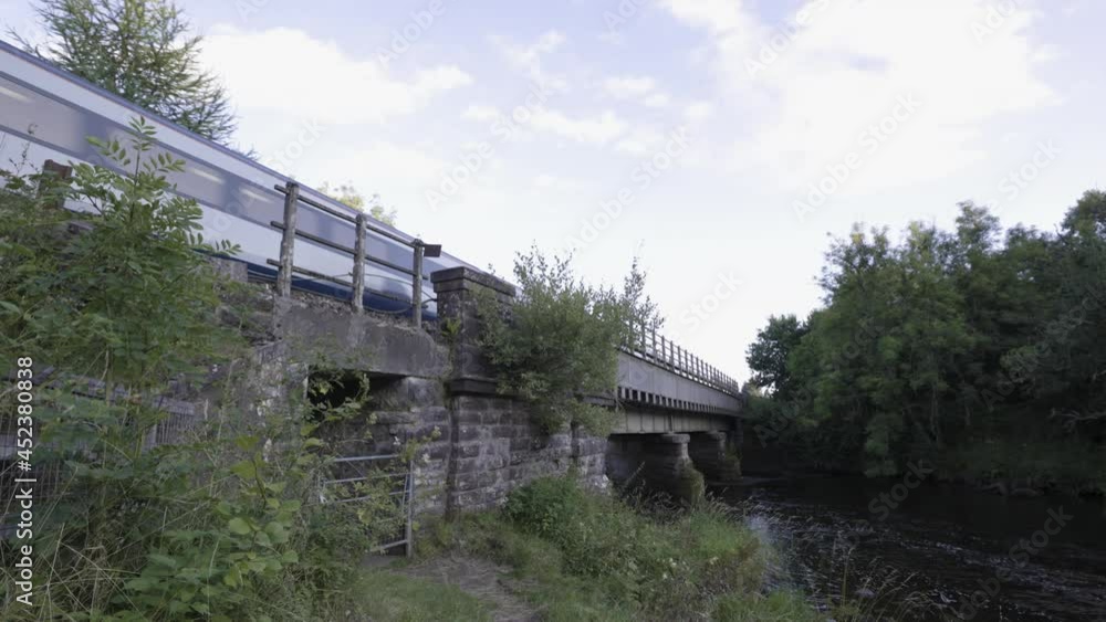 Passenger train passing over a bridge over a river. Passenger train passing over a bridge over a river.