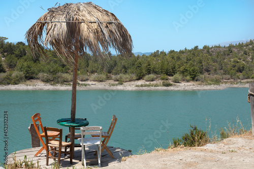 Adirondack chairs at lake s...