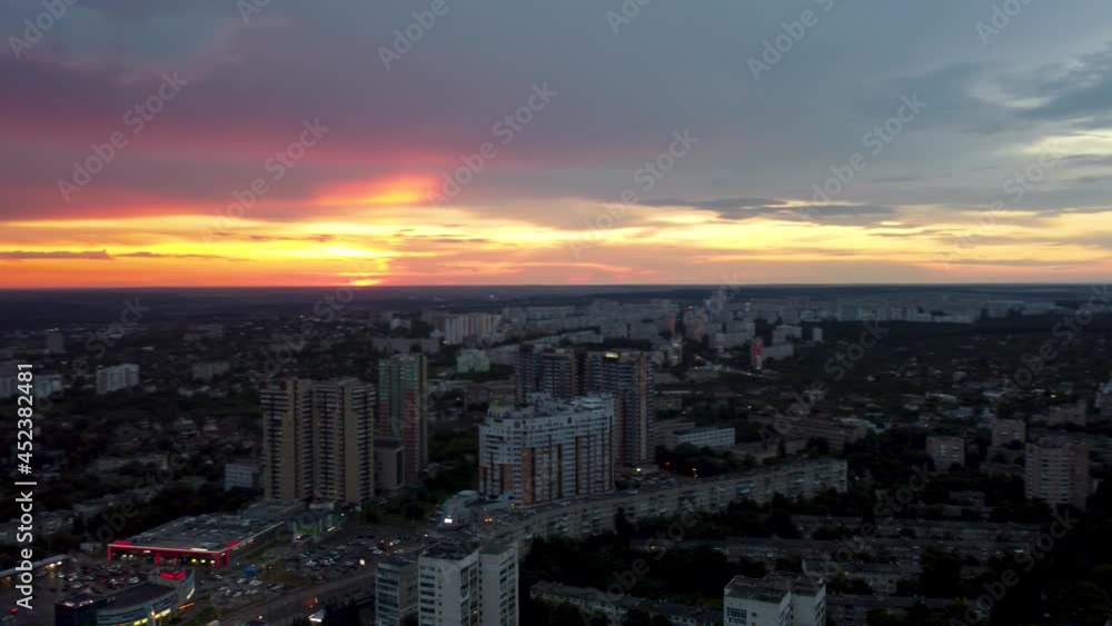 Epic vibrant sunset aerial . 23 serpnia street view in city residential district. Pavlovo Pole, Kharkiv, Ukraine. Fly with majestic evening skyscape, cloudscape and buildings silhouettes Epic vibrant sunset aerial . 23 serpnia street view in city residential district. Pavlovo Pole, Kharkiv, Ukraine. Fly with majestic evening skyscape, cloudscape and buildings silhouettes