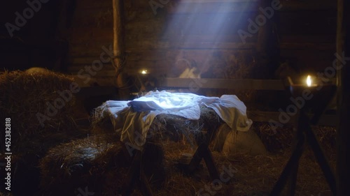 Manger with blanket in stable on Christmas day photo