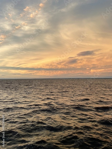 dramatic sunset clouds over bay water