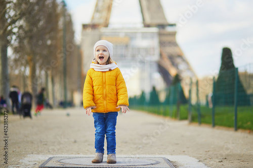 Adorable toddler girl walking near the Eiffel tower in Paris, France © Ekaterina Pokrovsky