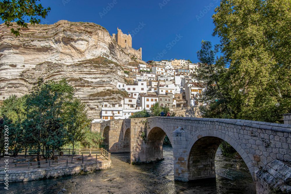 Alcala del Jucar, Spain. Picturesque and touristy white town in a meander of the Jucar river with a stone bridge. Considered tourist capital in the community of Castilla la Mancha, Albacete, Spain.