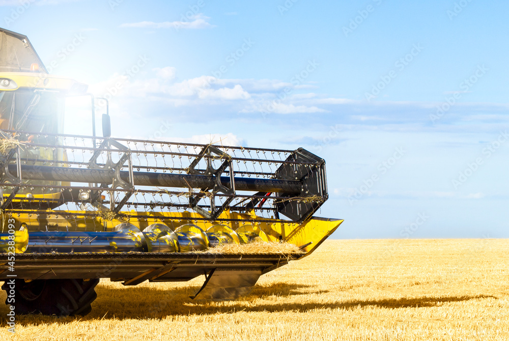 Fototapeta premium An up close view of a modern combine harvester in action.
