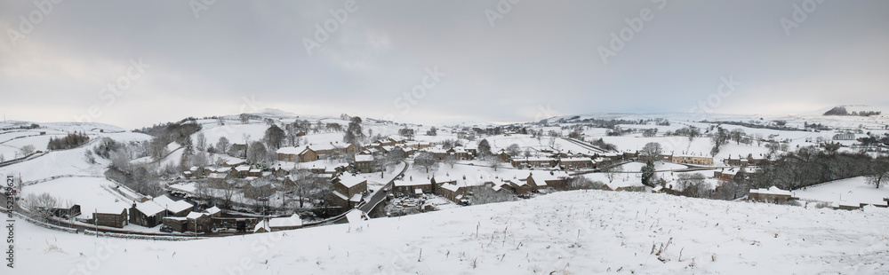 view of the North Yorkshire village of Bainbridge in winter covered in snow