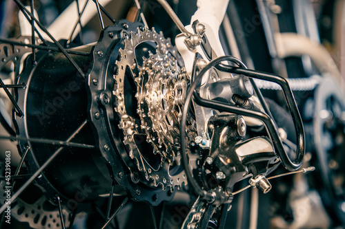 Close-up view of gears and derailer on an electric bicycle including the hub that contains the motor photo