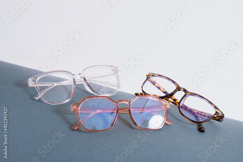 фотографія multiple pairs of eye glasses on dark gray wrapped paper, trendy fashion glasses