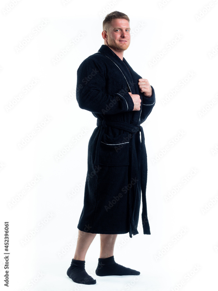 strong man in a Bathrobe on an isolated white background with a smile on his face. strong man in a Bathrobe on an isolated white background with a smile on his face.
