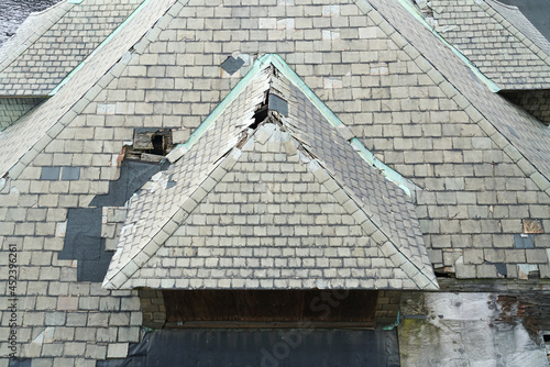  old damaged shingle on the roof