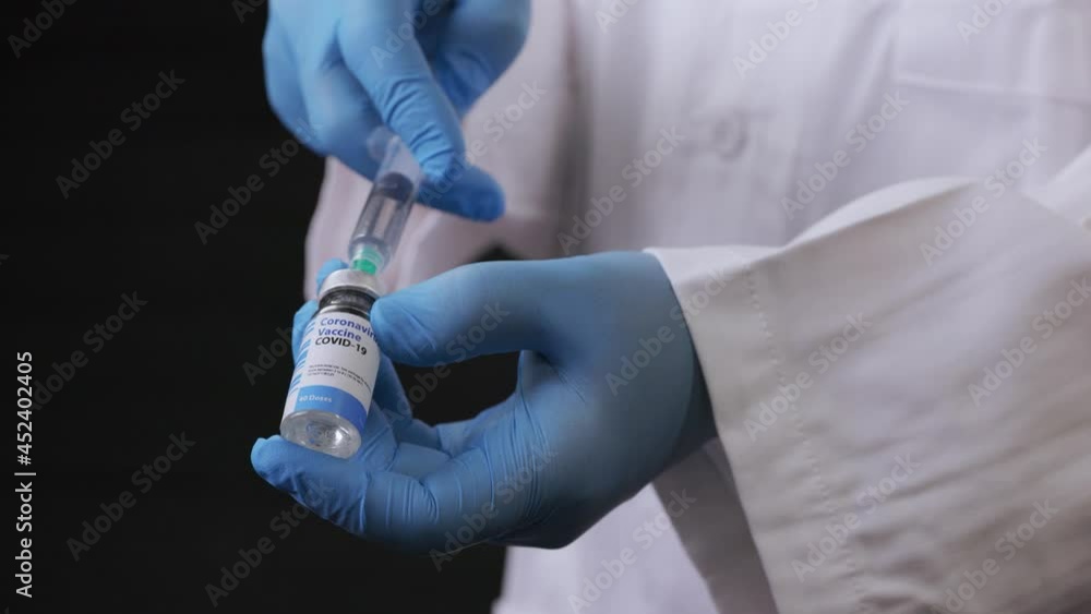 Preparing For Injection, A Doctor's Hands Fill The Syringe With Vaccine Preparing For Injection, A Doctor's Hands Fill The Syringe With Vaccine