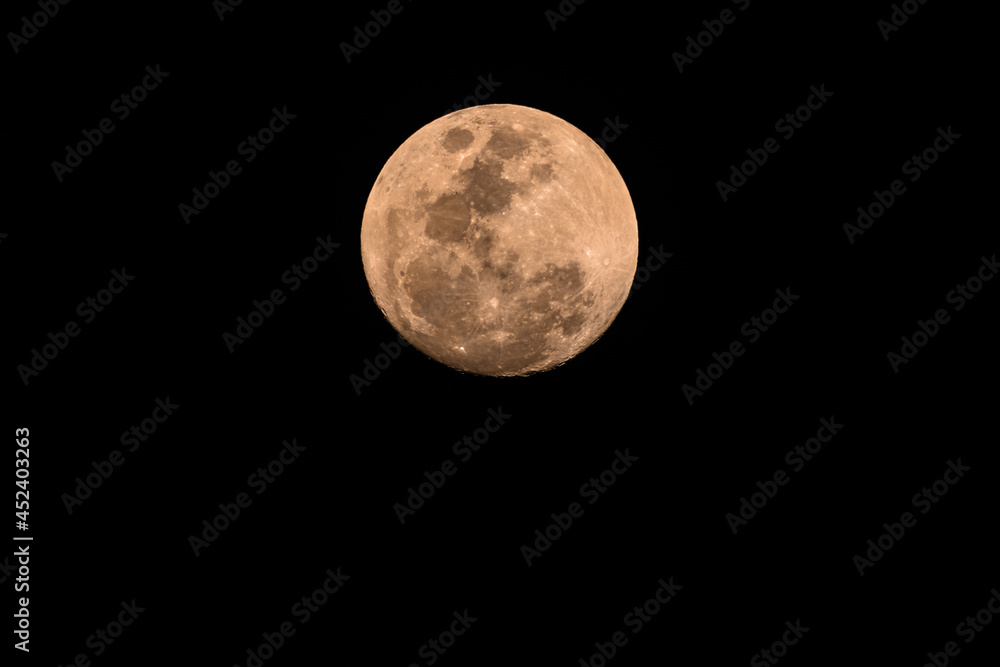Naklejka premium Ninety Nine Percent Full Moon in a hazy smoky night sky