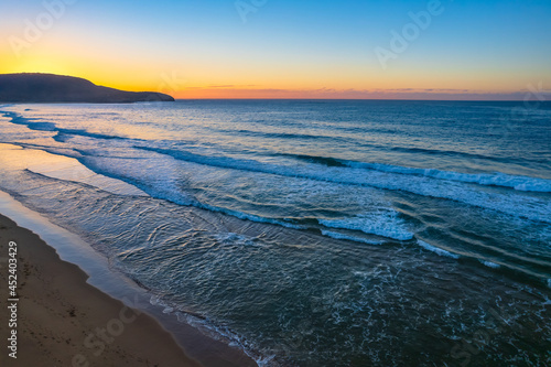 Aerial sunrise over the sea with clear skies