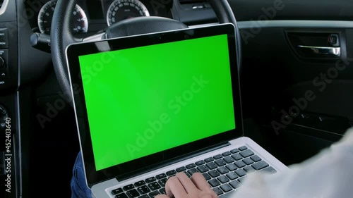 Wallpaper Mural Asian woman sitting in a car typing on keyboard and using laptop computer with chroma key green screen display, social distancing during delta covid pandemic , freelance job, new normal concept Torontodigital.ca