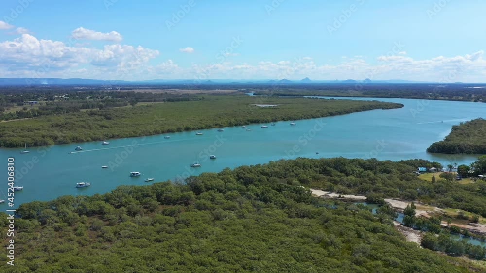 Fly over dense wetlands, boats on Caboolture River, Beachmere. Aerial forward Fly over dense wetlands, boats on Caboolture River, Beachmere. Aerial forward