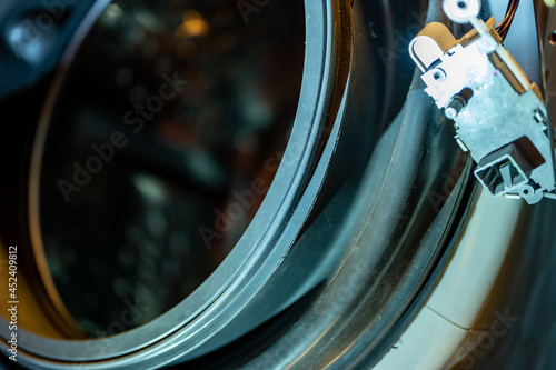 Selective Focus on the gasket mount of a front loading washing machine being serviced photo