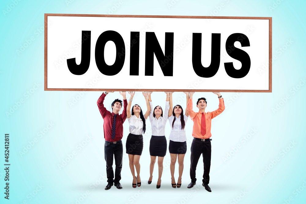 Group of business people lifting Join Us text Group of business people lifting Join Us text