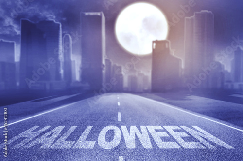 Halloween word on the road toward spooky city