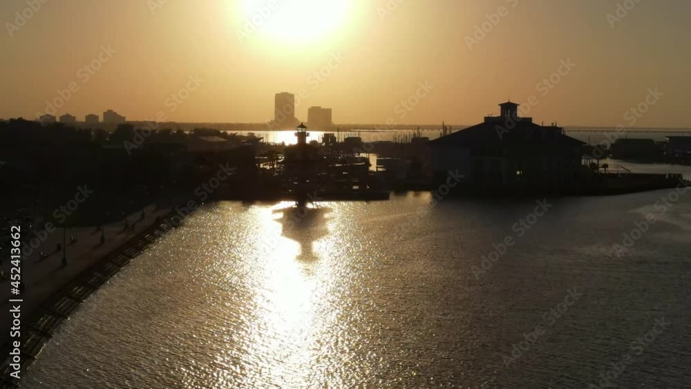 Sunset Over Lakeshore Of Pontchartrain With Silhouetted Structures Near New Orleans In Louisiana, USA. - Aerial Sunset Over Lakeshore Of Pontchartrain With Silhouetted Structures Near New Orleans In Louisiana, USA. - Aerial