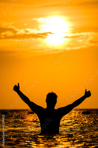 silhouettes of people on the sea, warm sunshine on the morning, at Haadrin beach, koh phangan, surathhani , thailand © kongkiat chairat