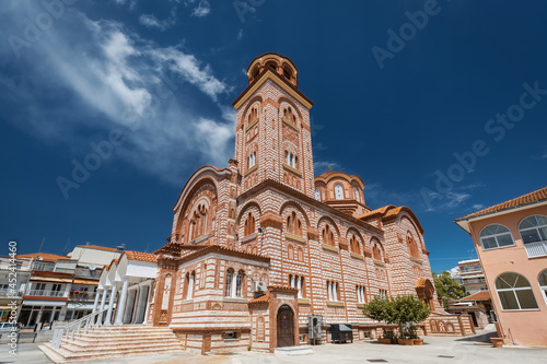 Giant Greek Orthodox cathedral against vivid blue sky in a small Mediterranean town near Thessaloniki