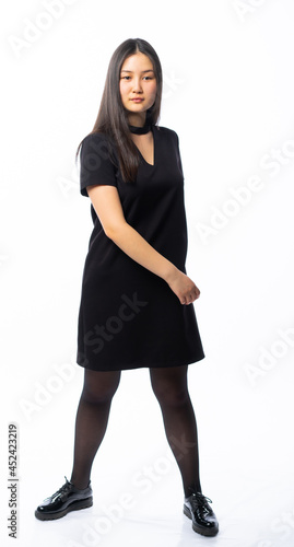 portrait of a girl in a black dress with long black hair on a white background. Oriental beauty