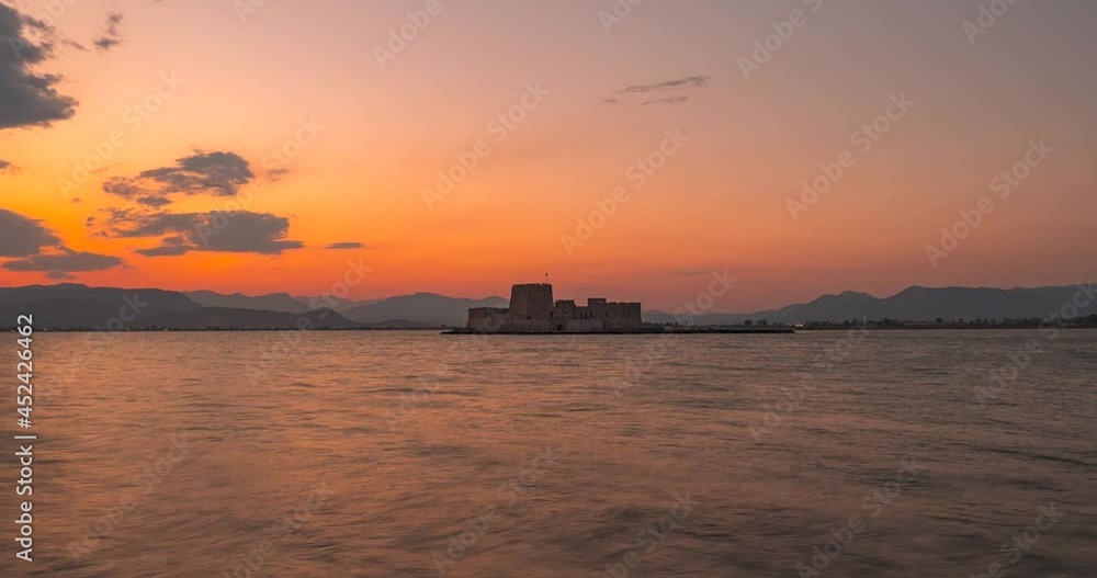 Sunset time lapse view of Bourtzi Castle in Nafplion, Peloponnese region of mainland Greece Sunset time lapse view of Bourtzi Castle in Nafplion, Peloponnese region of mainland Greece
