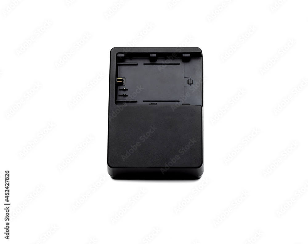 Used black old camera charging adapter on isolated white background Used black old camera charging adapter on isolated white background
