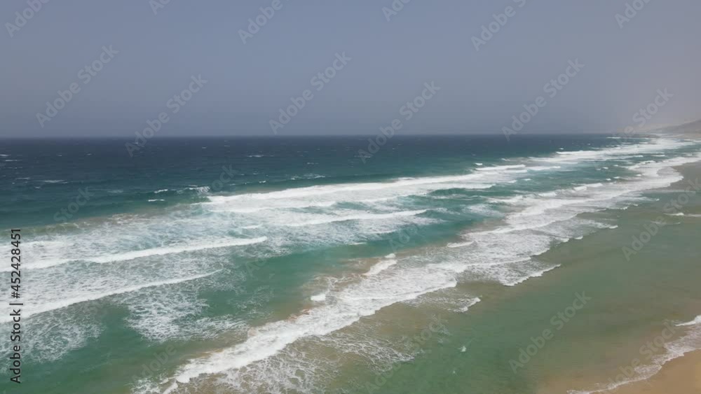 aerial drone shot of big waves crashing on the beach of cofete in Fuerteventura, canary island. aerial drone shot of big waves crashing on the beach of cofete in Fuerteventura, canary island.