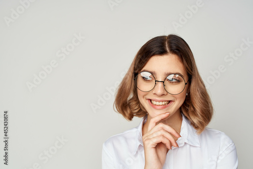 cheerful business woman in shirt and glasses manager work studio