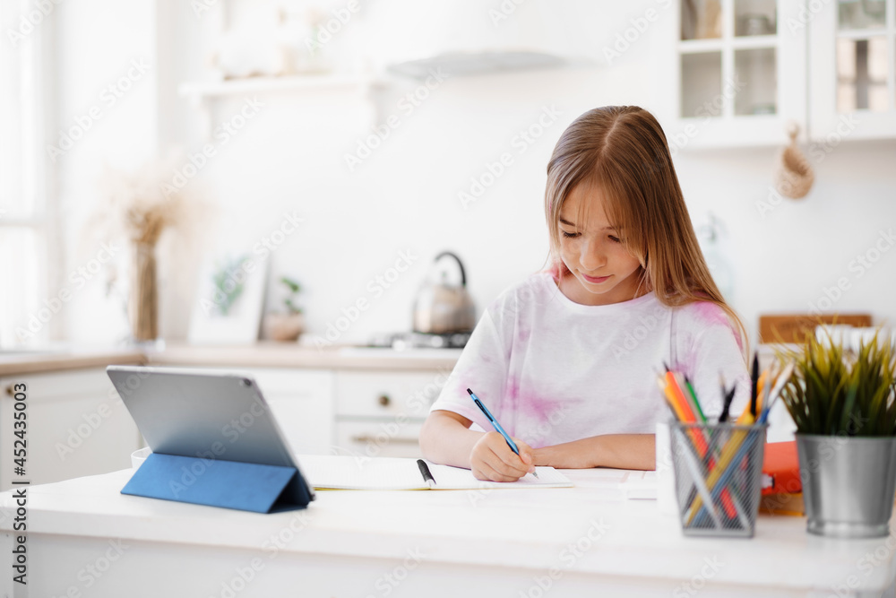 Homeschooled little young girl student having online class using digital tablet Homeschooled little young girl student having online class using digital tablet