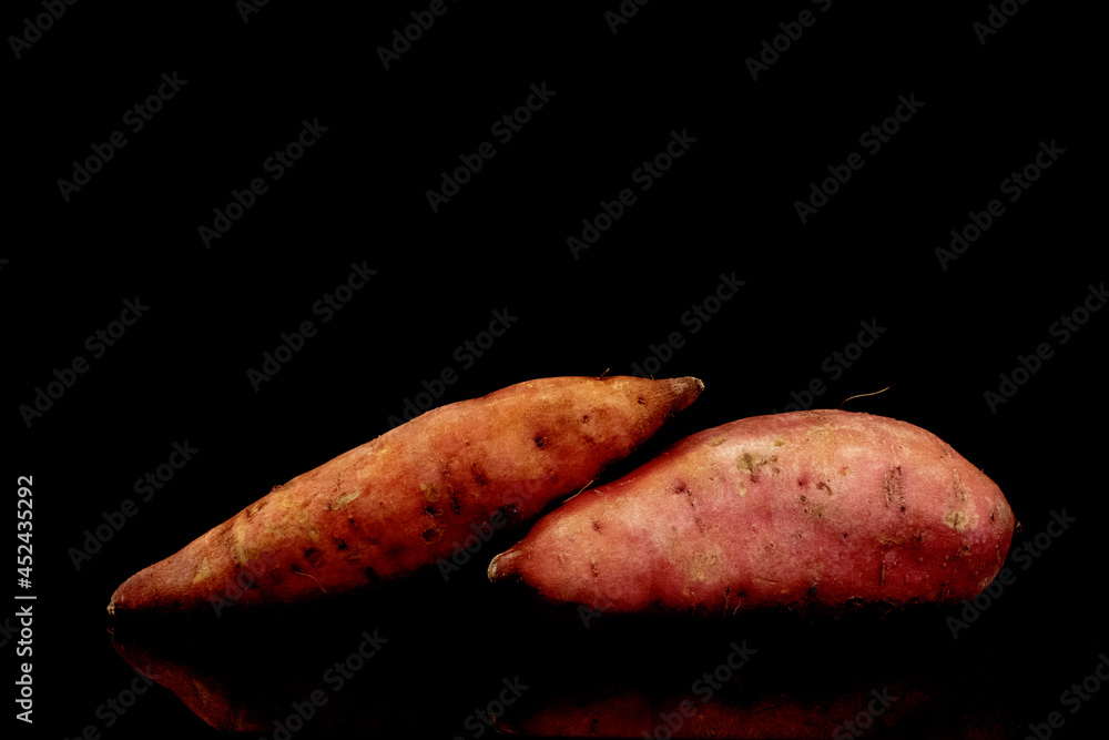 Two fresh organic sweet potatoes, close-up, isolated on white. Two fresh organic sweet potatoes, close-up, isolated on white.