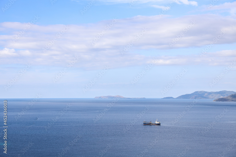 Sea background with Fishing boat sailing under blue sky