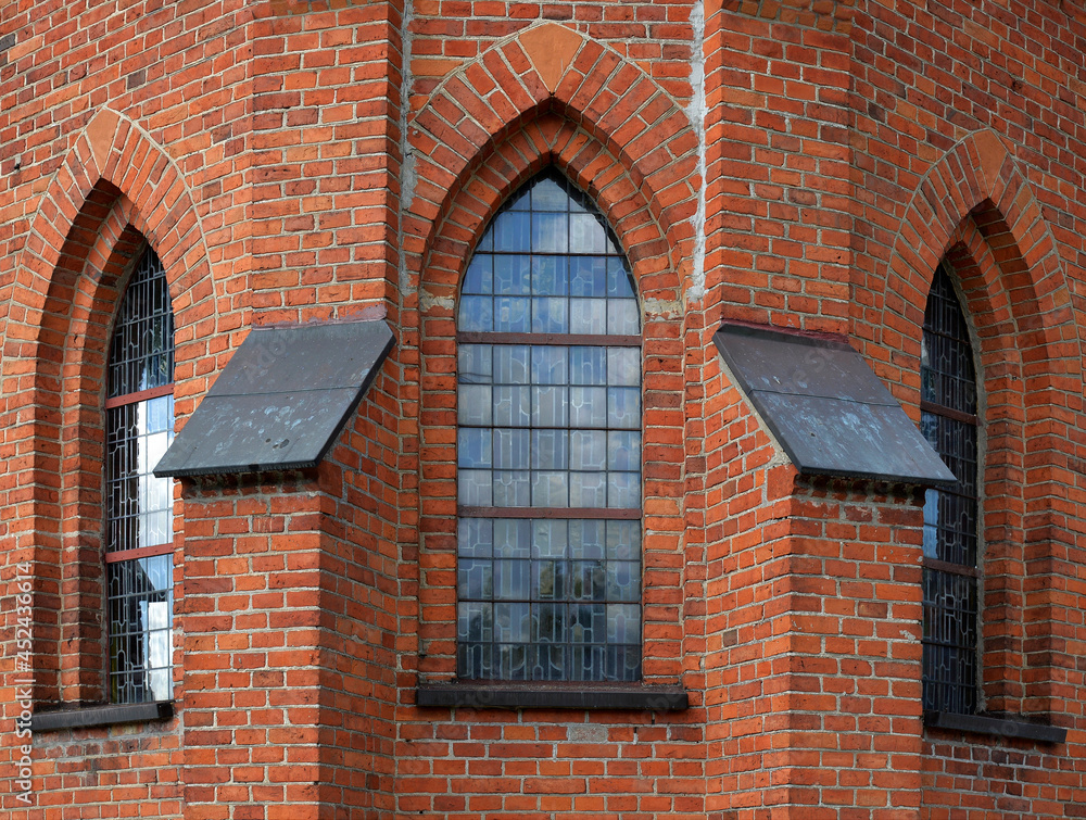 Obraz premium General view and architectural details of the Catholic Church of the Exaltation of the Holy Cross built in 1861 in the neo-Gothic style in the city of Olecko in Masuria, Poland.