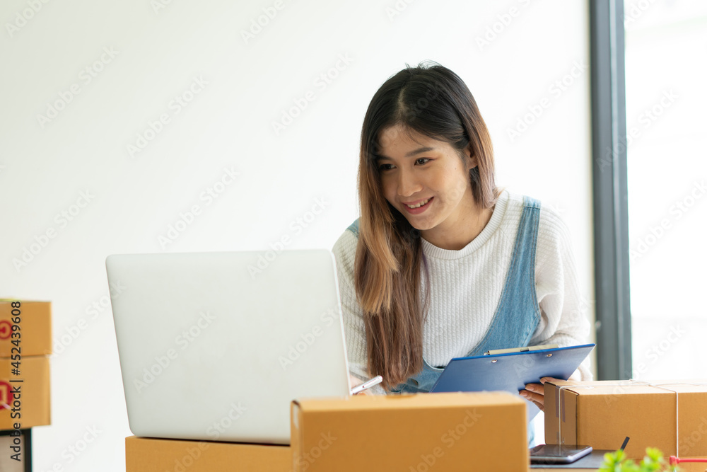 SME business online and delivery concept, freelance woman working at home with Online Parcel delivery. SME business online and delivery concept, freelance woman working at home with Online Parcel delivery.