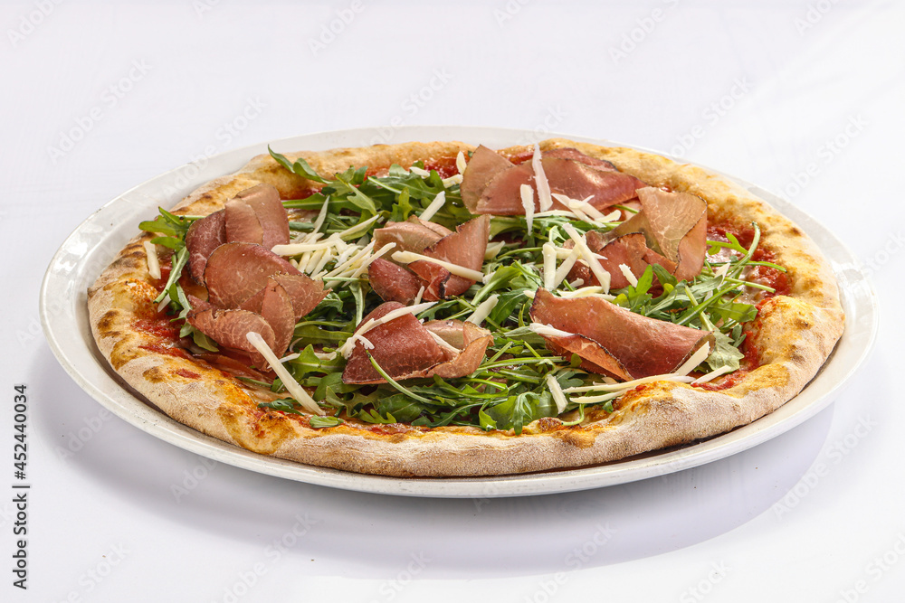 Italian pizza with prosciutto and ruccola Italian pizza with prosciutto and ruccola