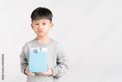 Asian boy holding 1000 cc, a liter plastic bottle