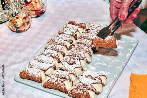 Let's party with many typical sicilian cannoli stuffed with ricotta and cream photo