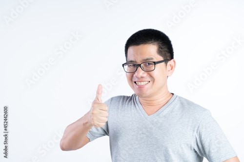 Middle aged Asian man with glasses doing a thumbs up gesture