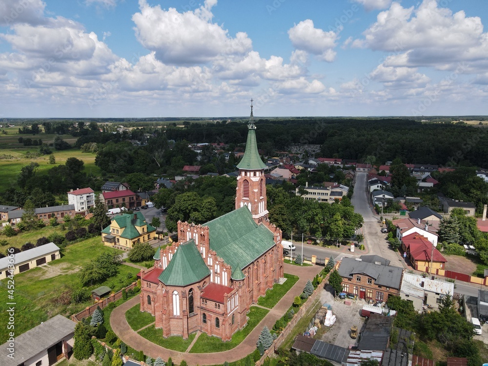 The historic church on the background of a small town - photo from the drone 
