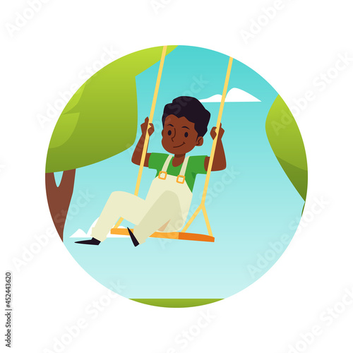 Cute boy having fun on rope swing in park on amusement attractions or playground