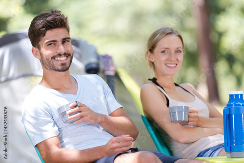 man and woman talking and smiling outdoors in forest
