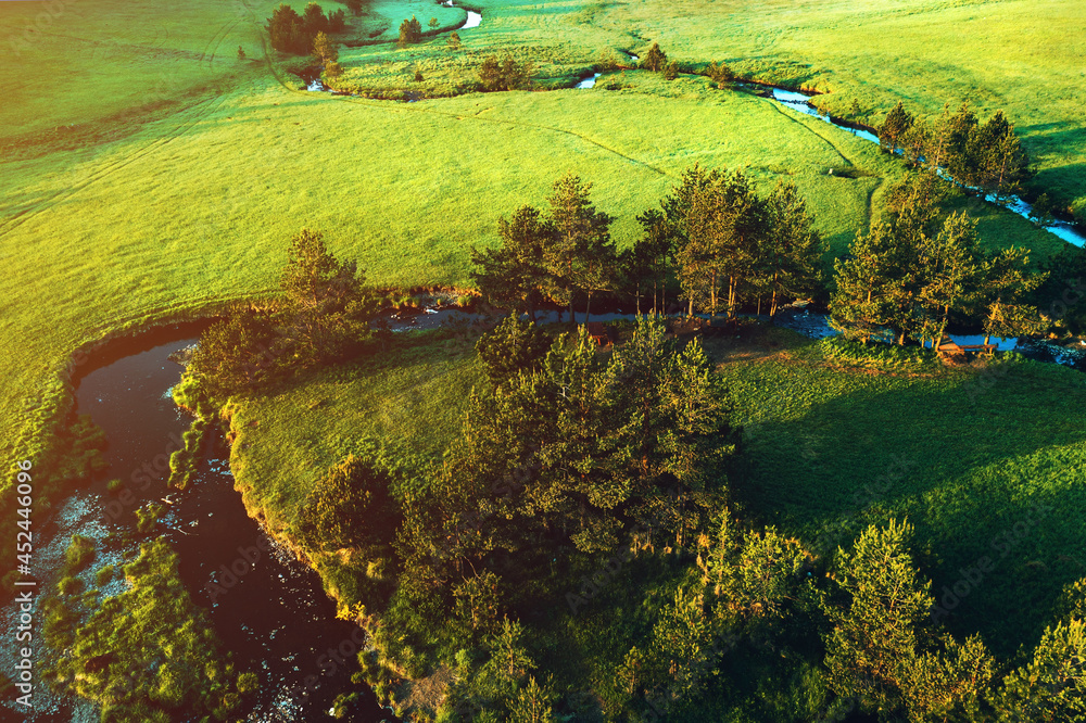 Aerial view of mountain creek winding through beautiful grassy landscape on Zlatibor, Serbia Aerial view of mountain creek winding through beautiful grassy landscape on Zlatibor, Serbia