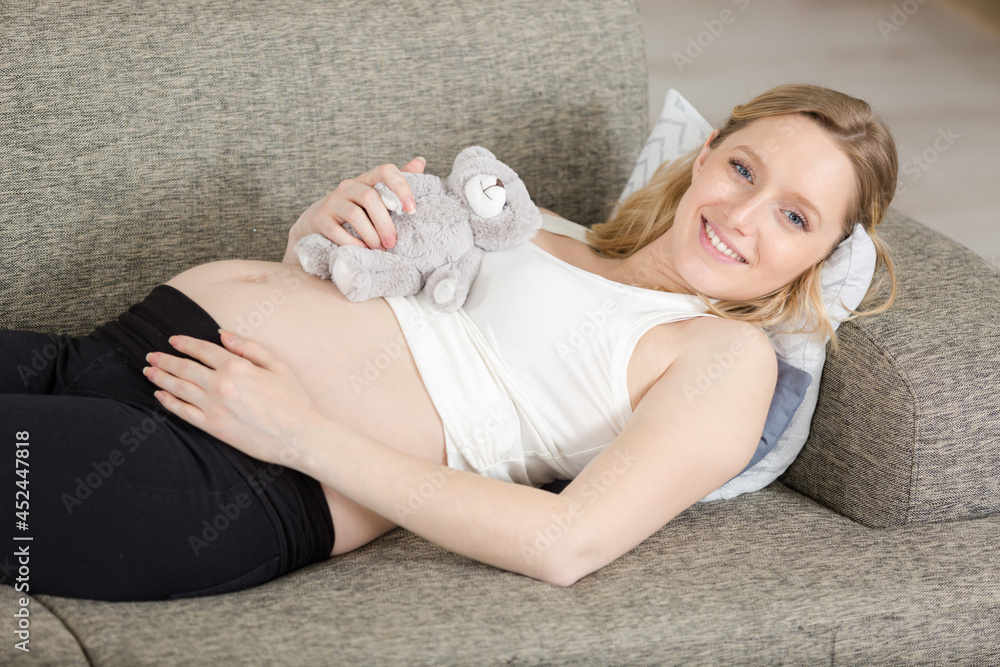 pregnant woman holding fluffy teddy bear pregnant woman holding fluffy teddy bear