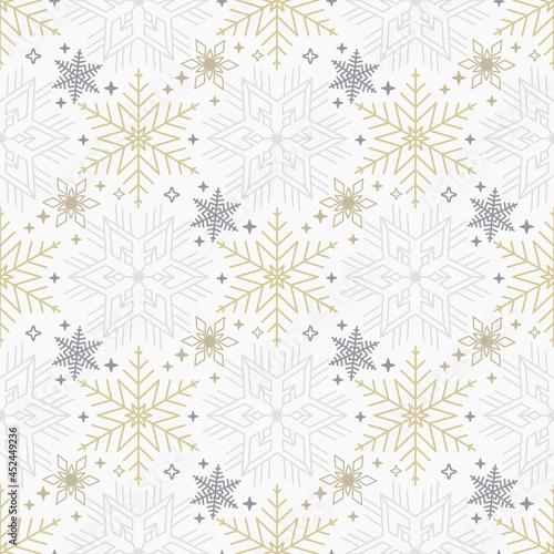 Seamless Christmas background with scattered gold and gray snowflakes